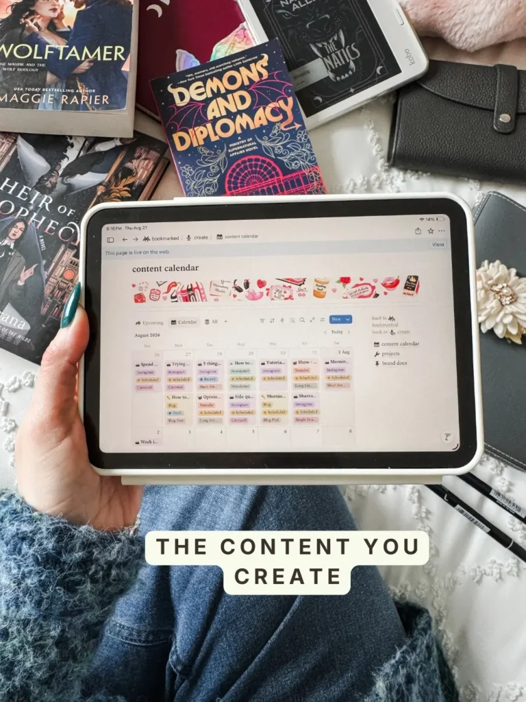 The content calendar in Bookmarked, an August month view with posts tagged by platform and status. Caption: The content you create.