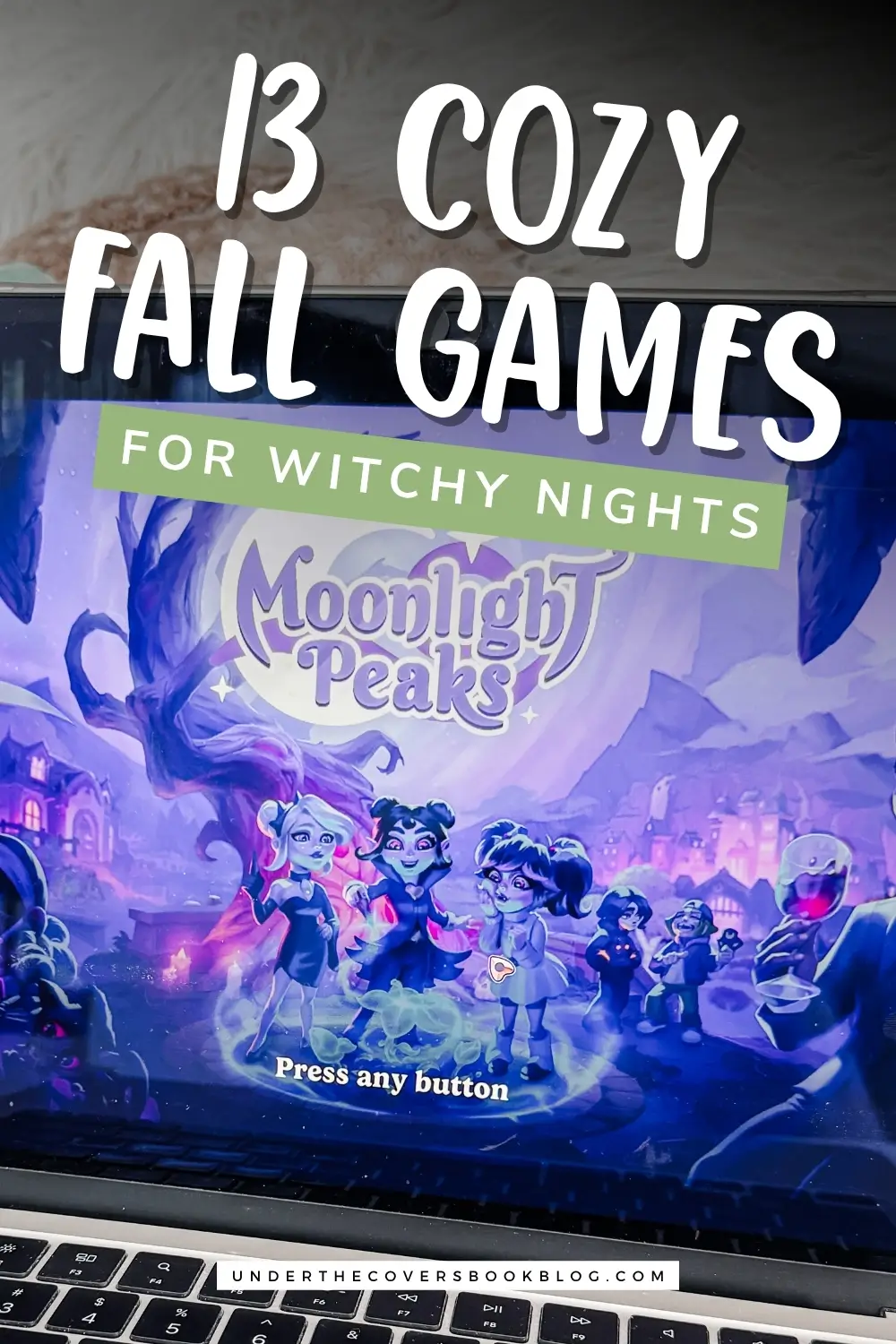 Pinterest graphic titled "13 cozy fall games for witchy nights" over a photo of the Moonlight Peaks title screen open on a MacBook
